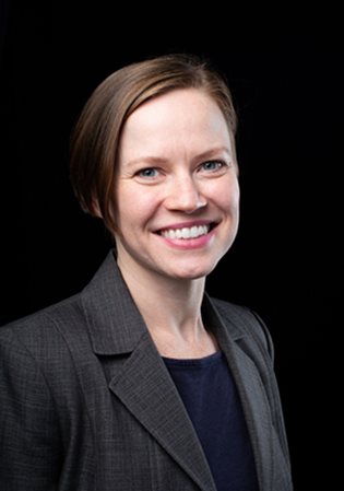 Woman with short dark hair smiles